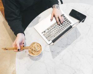 productive employee eating while working display good employee engagement