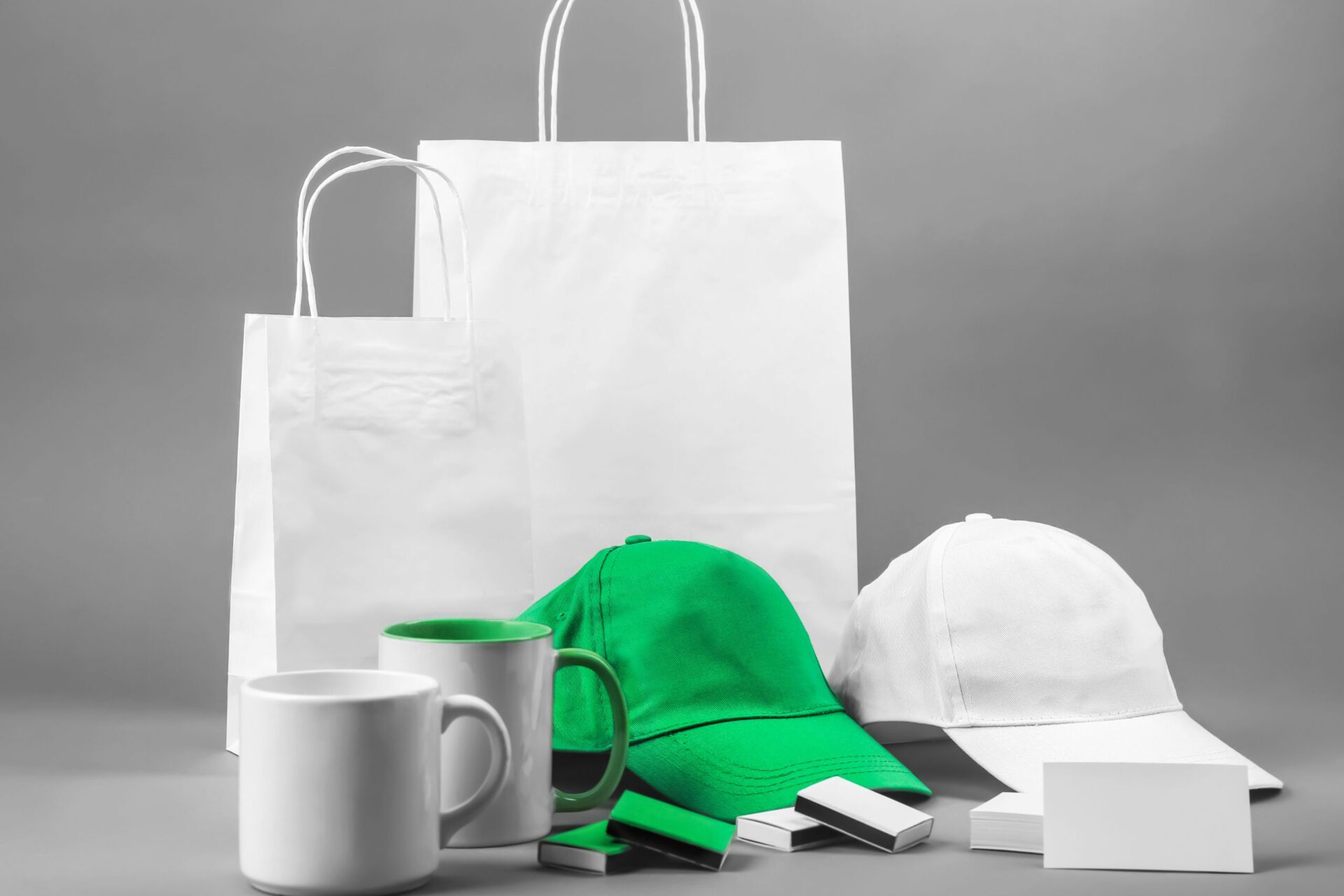 an array of white, unbranded merchandise with one green hat