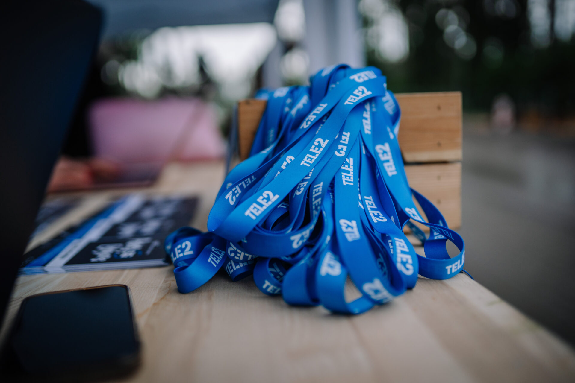 Branded lanyards stacked on an event table