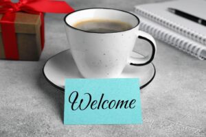 employee welcome gift on desk next to computer and cup of coffee